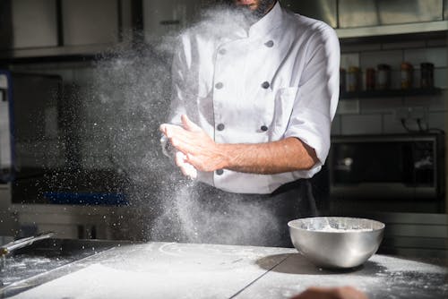 A Chef Using Flour in the Kitchen