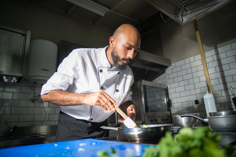 A Chef Cooking In The Kitchen