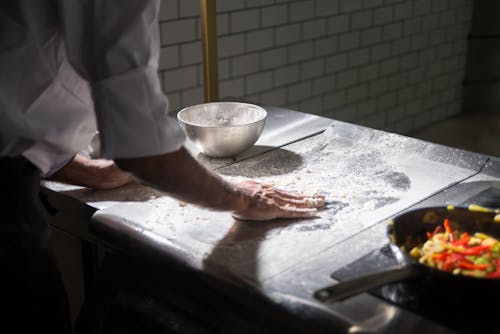 A Person Kneading a Dough on the Table