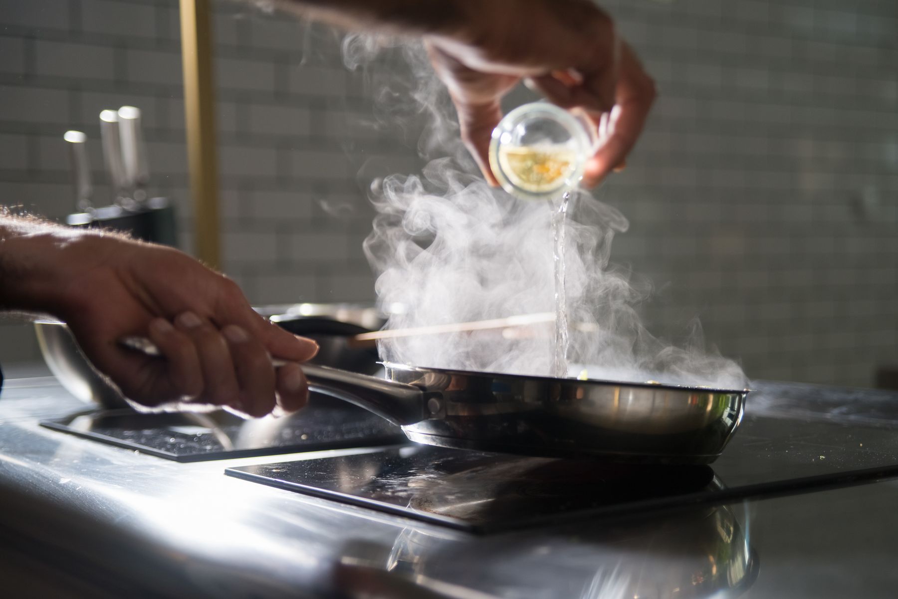 Home cook carefully preparing food at a modern kitchen worktop
