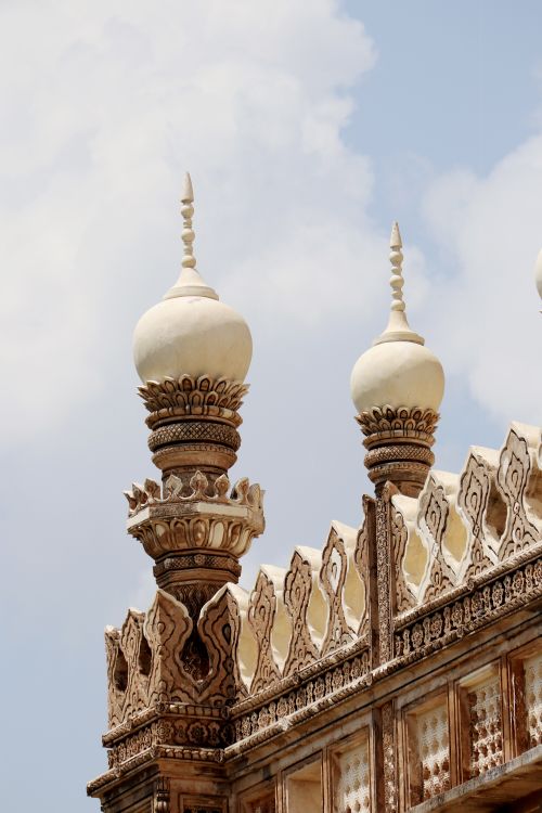Free Close-up of ornate spires on a historic building against a blue sky. Stock Photo