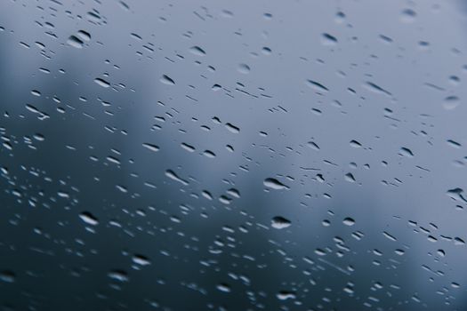 Close-up view of raindrops on a window, capturing the essence of a stormy day.