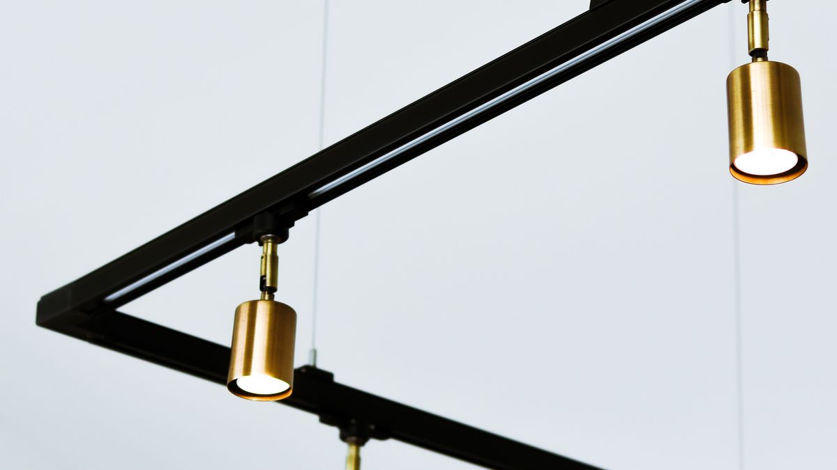 Elegant minimalist gold hanging lights on geometric frame in modern interior