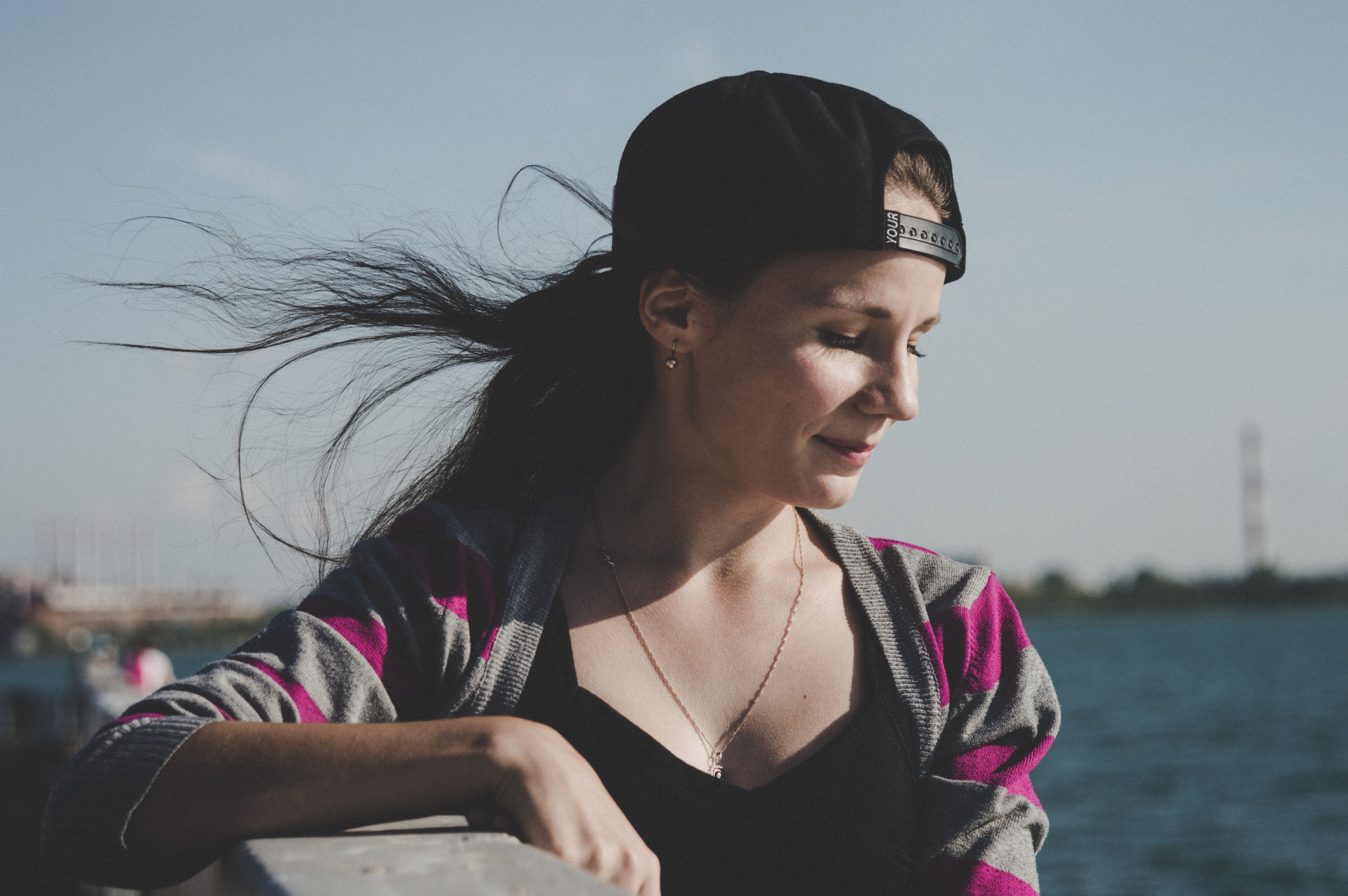 Selective Focus Photography of Female Wearing Black Snapback Near Ocean ...
