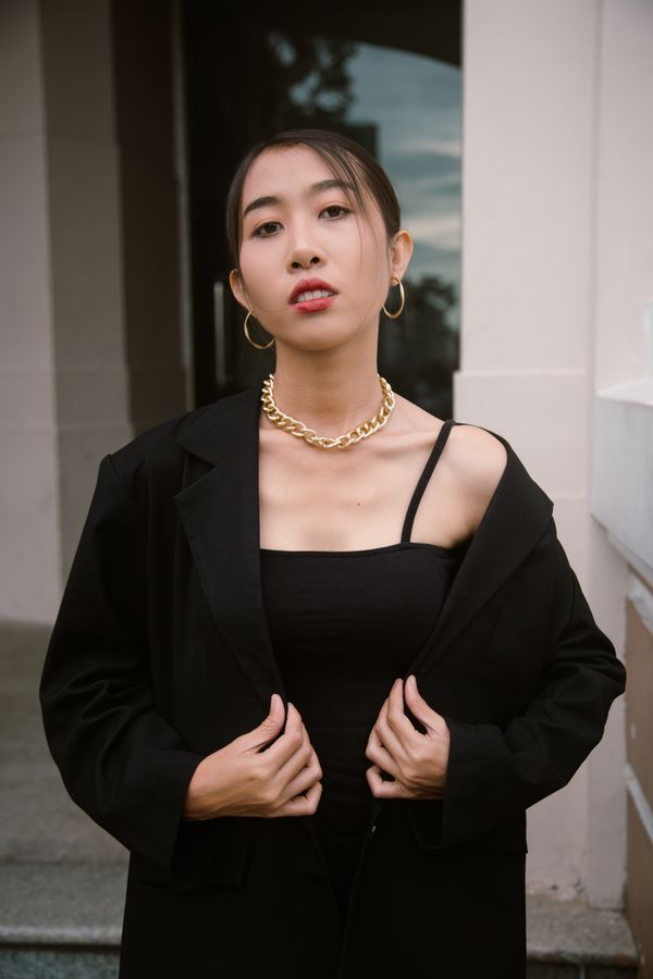Woman in a blazer over a lace camisole, evening outfit