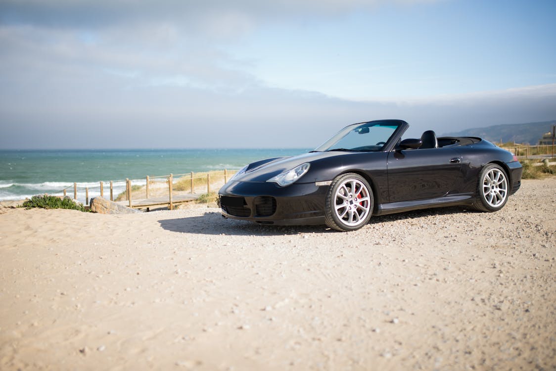 Free A Cabriolet Parked Near a Beach Stock Photo