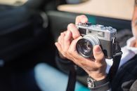 Person Holding Black and Silver Camera