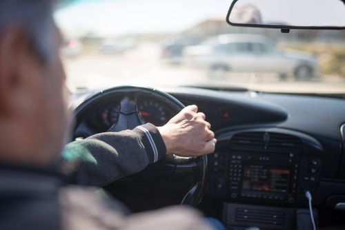 Free Adult man driving a car with focus on dashboard and steering, capturing the essence of travel. Stock Photo