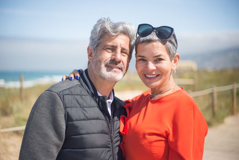 An older couple smiling together outdoors