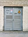 Gray Louver Door on Beige Brick Wall