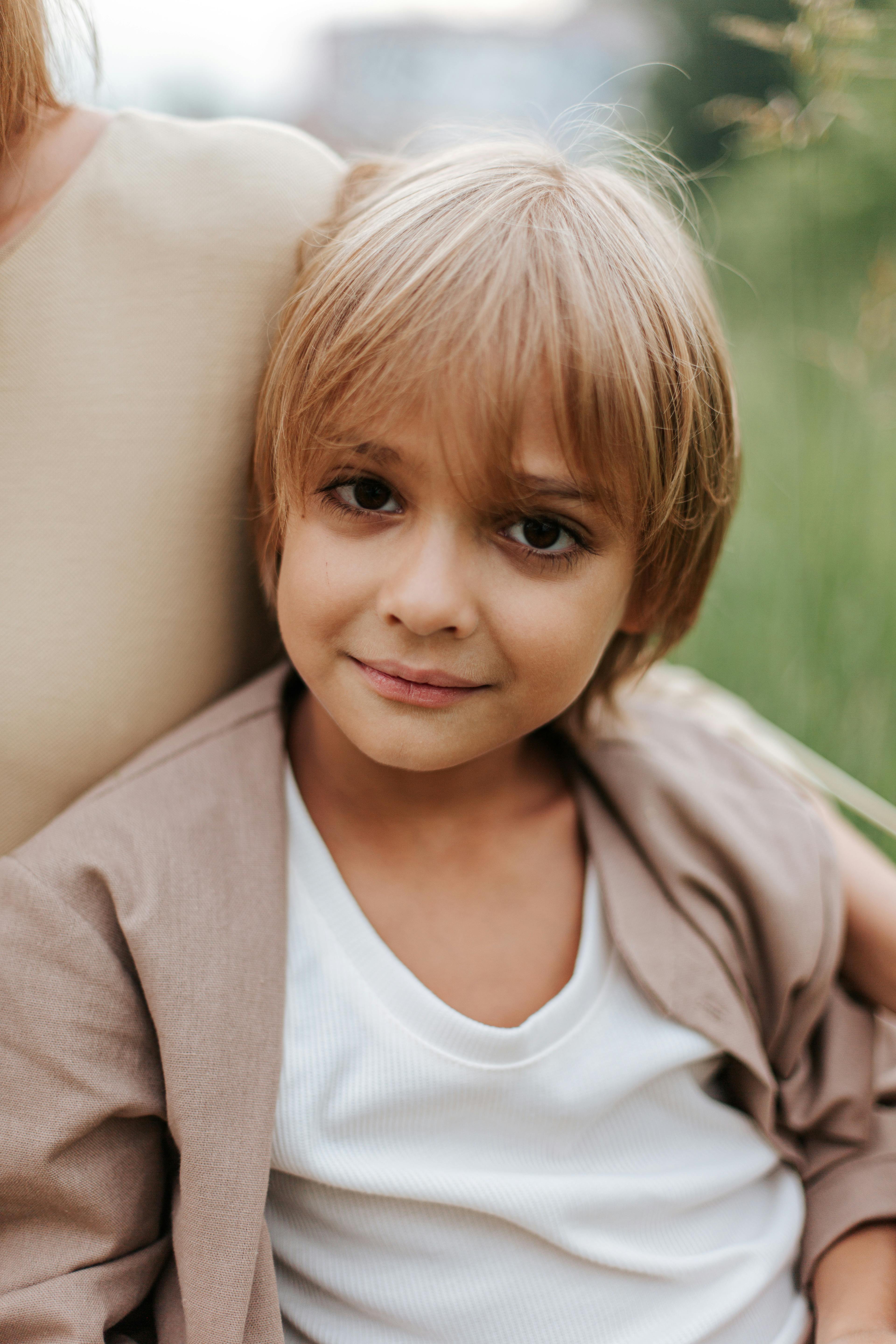 Portrait of a young boy outdoors, exuding charm and innocence.