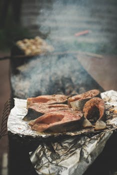 Close-up of salmon steaks being grilled outdoors on a barbecue in Karelia, Russia.
