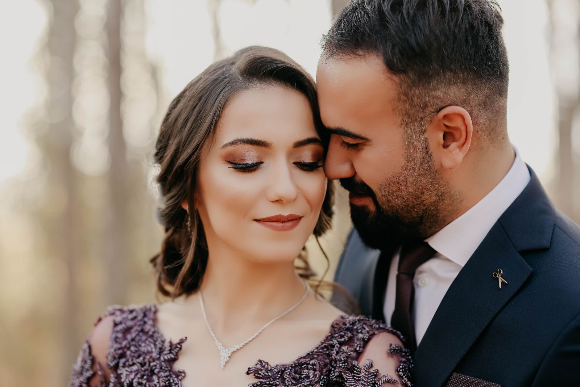 Close-up of a romantic couple sharing a tender moment outdoors.