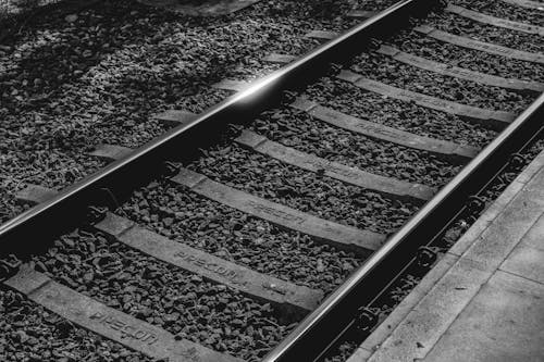 Grayscale Photo of a Railroad Track