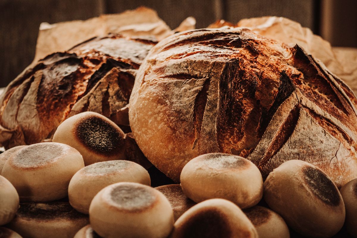 Rustic sourdough loaves and rolls fresh from the oven, by Lauren Heaton on Pexels