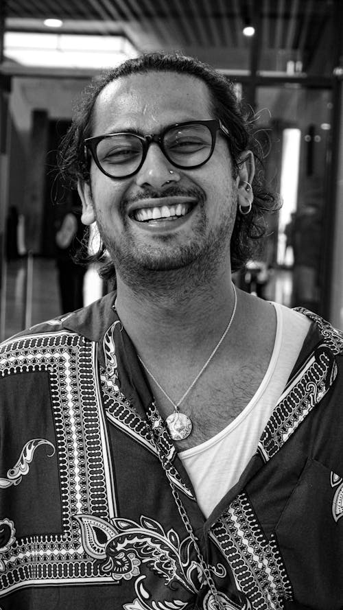 Grayscale Photography of Smiling Man Wearing Black Framed Eyeglasses