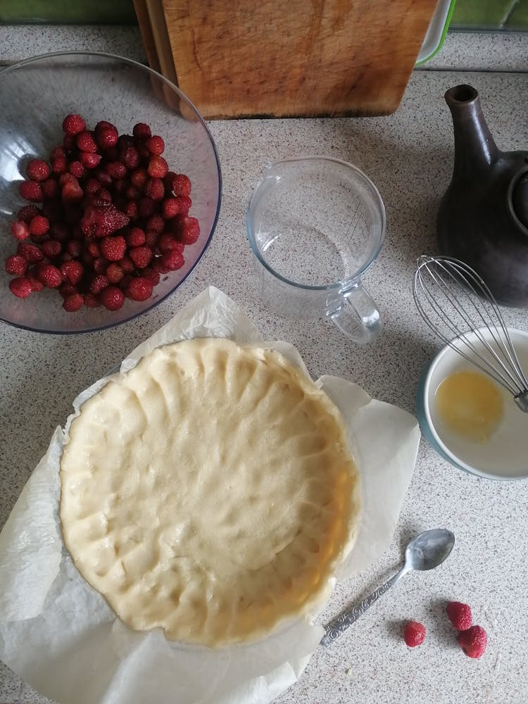 Raw Pie Crust And A Bowl Of Raspberries
