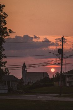 A stunning silhouette of a church with power lines at sunset in Smooth Rock Falls, Ontario, Canada.