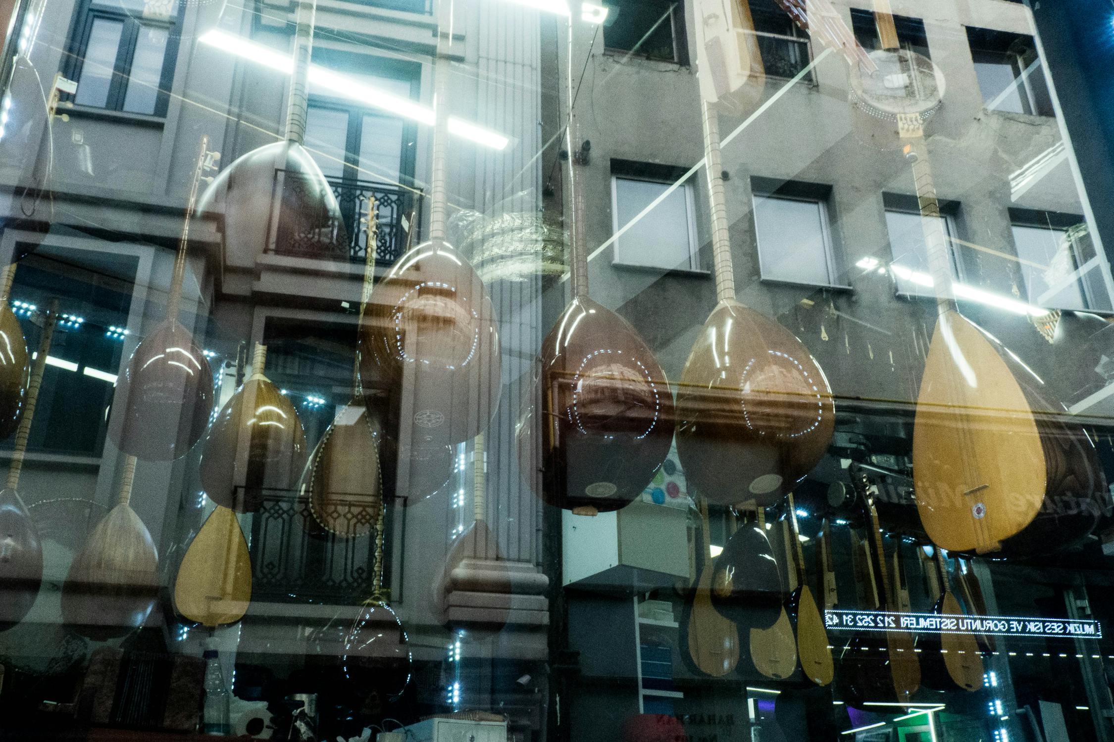 Building Facade Reflecting in Glass and Traditional Music Instruments ...