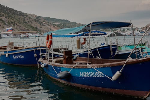 Brown and Blue Boats Docked on Harbor