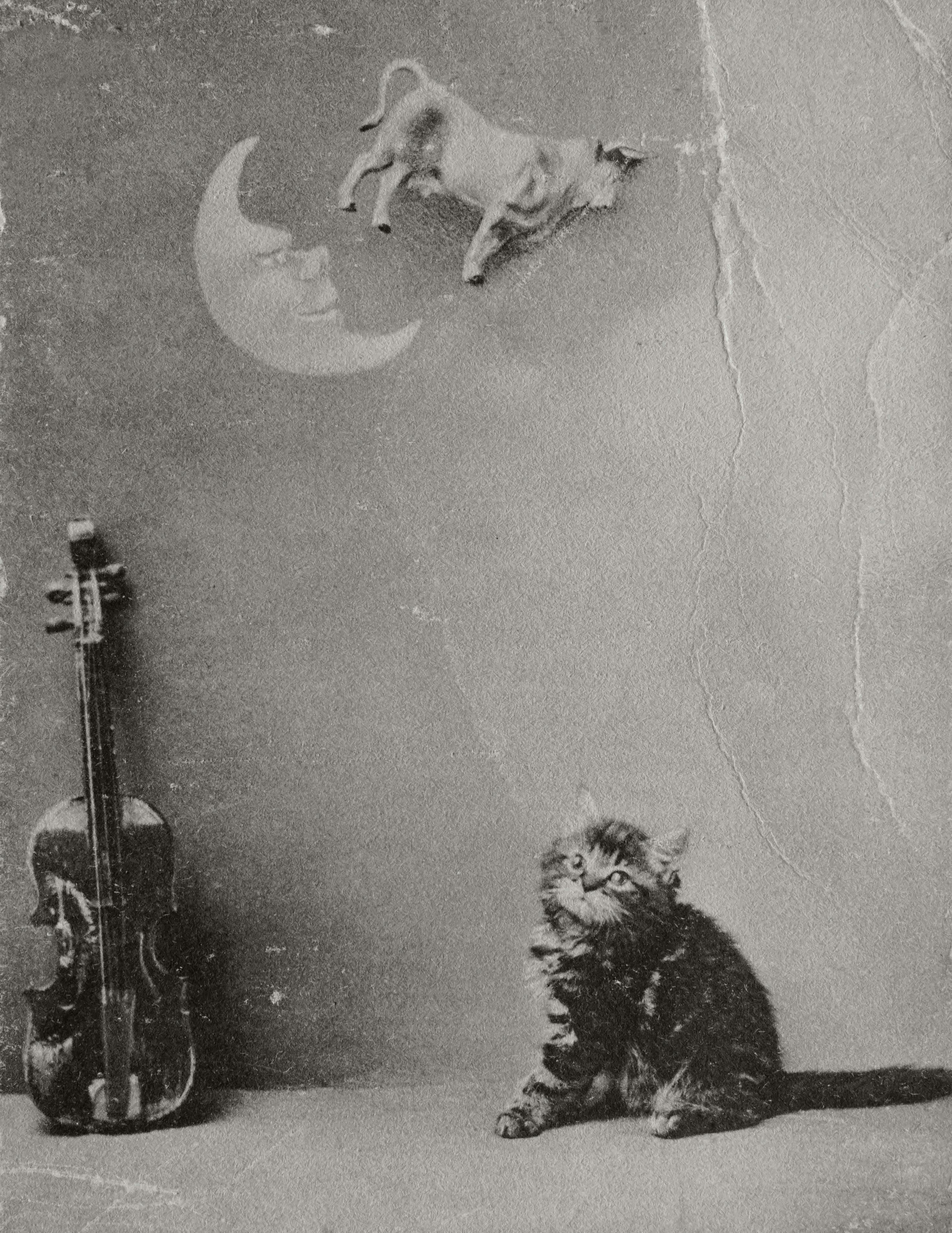 Whimsical grayscale image with a kitten, cow jumping over moon, and violin in a vintage style.