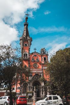 Explore the unique Gothic architecture of Iglesia Yurrita under a vibrant blue sky, captured during daylight.