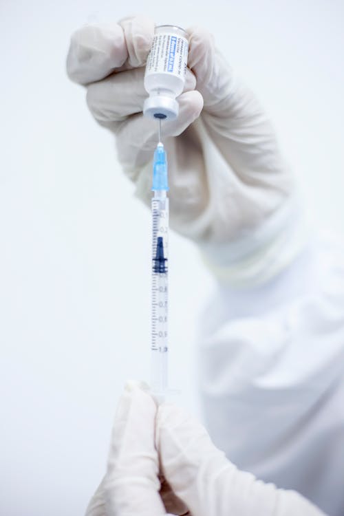 Free A Person Holding a Vaccine Bottle Stock Photo