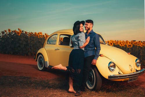 A Couple Standing Near the Car