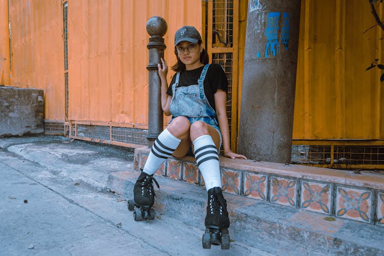 A Woman In Denim Jumper Wearing Skates