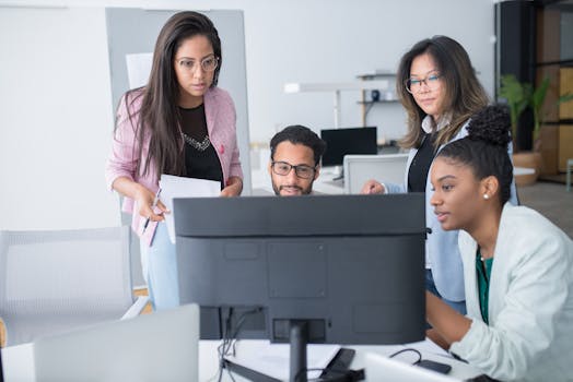 A diverse team of professionals collaborating on a project in a modern office environment.