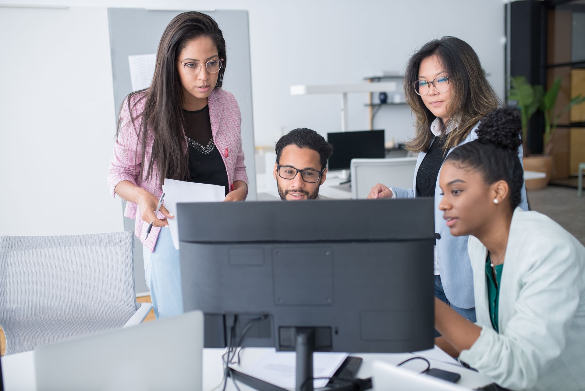 People in the Office Using a Desktop Computer for Discussion