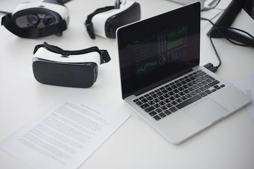 Close-Up Shot of a Laptop beside VR Glasses