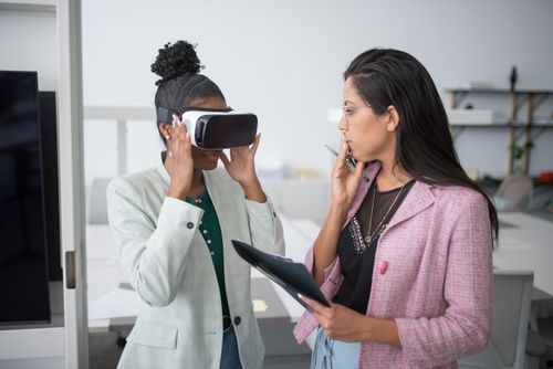 Free Two professional women collaborating using VR technology in a modern office setting, showcasing innovation. Stock Photo
