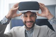 A Man in Gray Coat Wearing a Virtual Reality Goggles