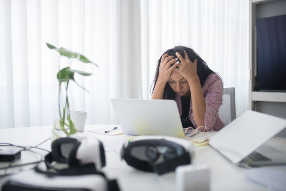 Can Stress Cause Bad Breath? The Anxiety Loop Nobody Warns You About 2 Woman working under pressure, illustrating how stress disrupts daily oral care routines
