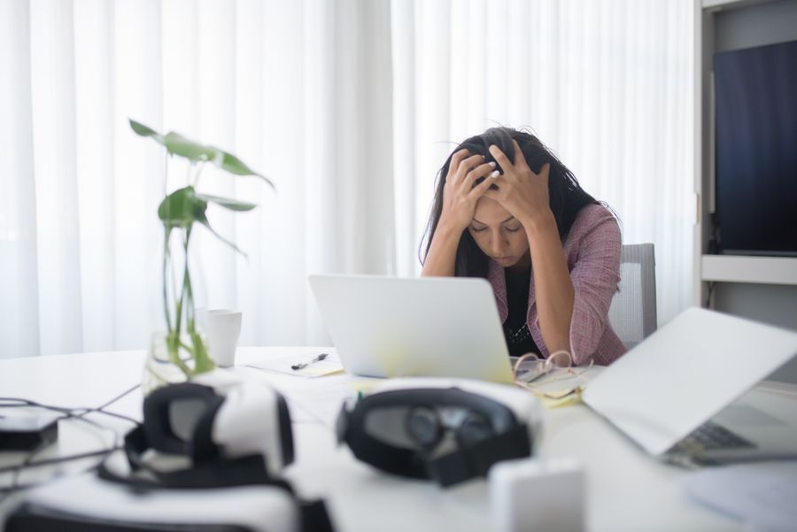 A founder at her desk, overwhelmed by unedited footage and unfinished captions