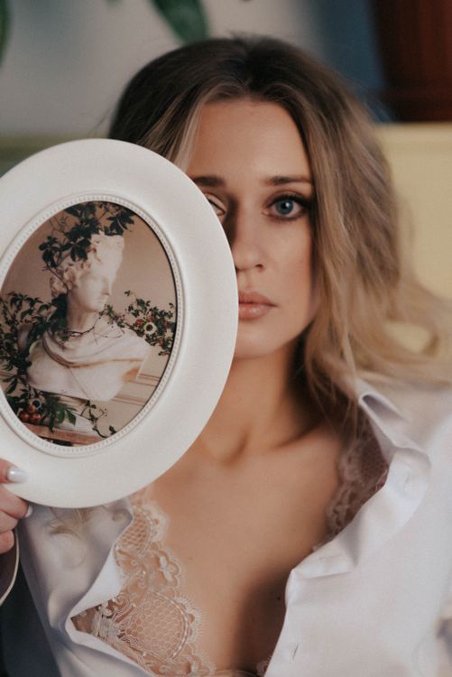 A Woman Holding a Round Picture Frame · Free Stock Photo