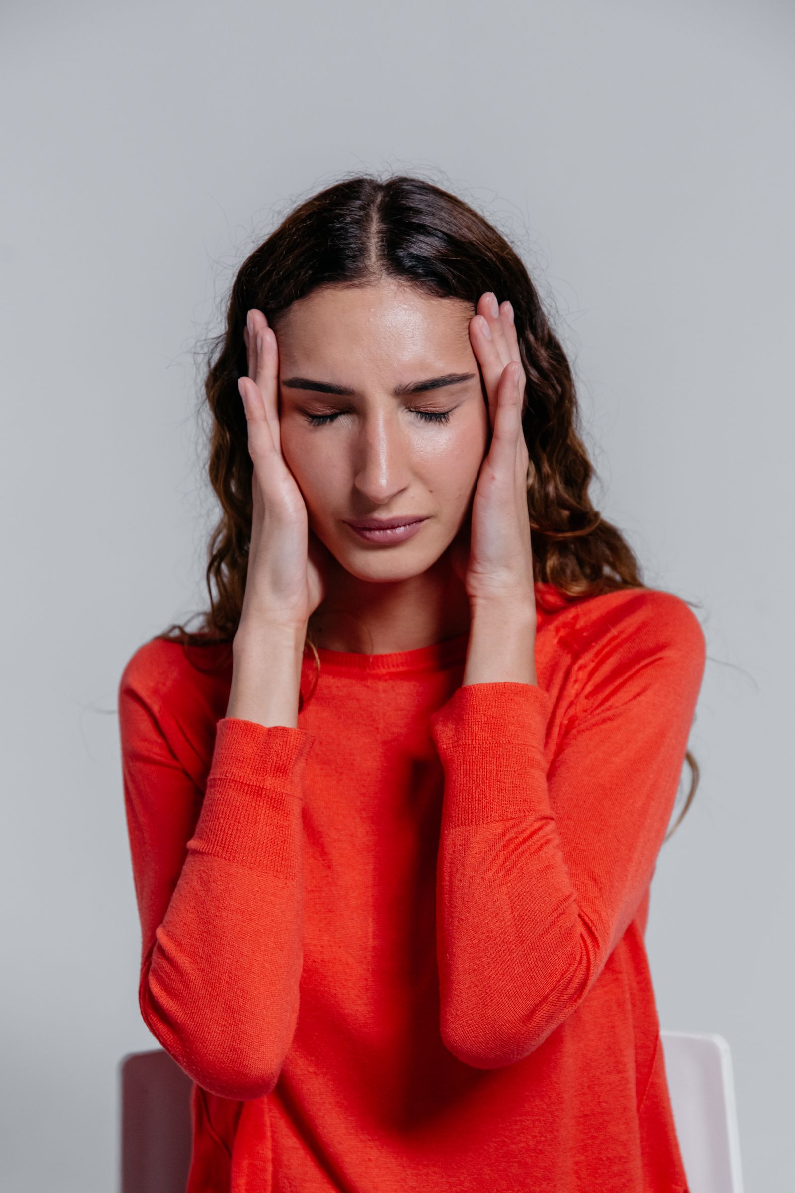 Woman holding her head with a headache