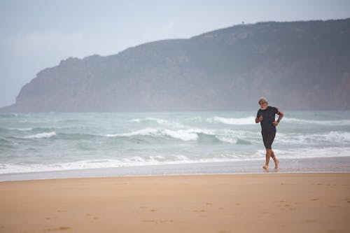 A Man Running Near the Shore
