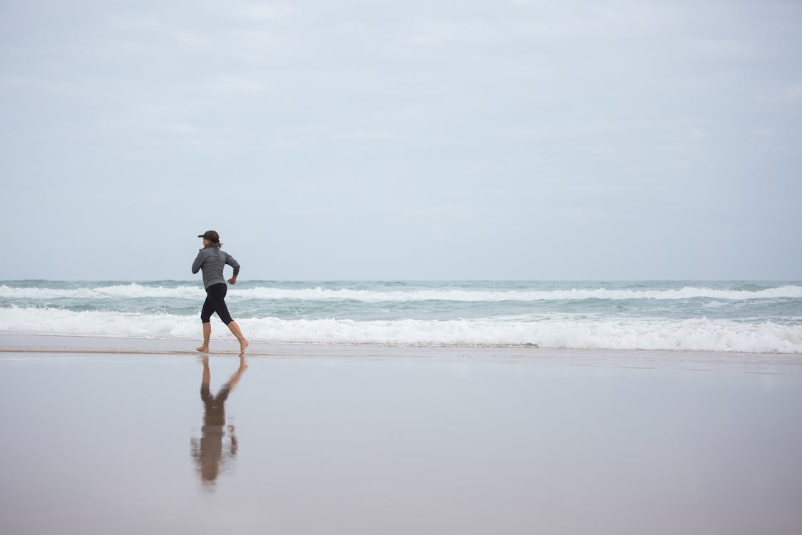 A Woman Running on the Shore