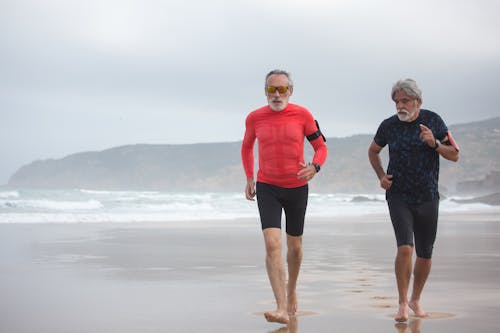 Elderly Men Running on the Shore