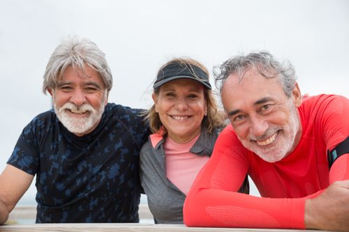 Free Senior friends in Portugal smiling and enjoying an outdoor fitness activity. Stock Photo