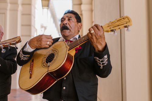 Free A mariachi musician playing guitar at a fiesta, highlighting cultural music traditions. Stock Photo