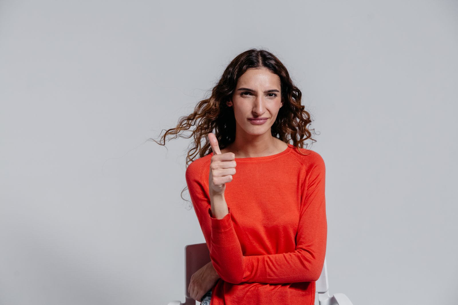 Person adjusting a finger and hand support during daily activity