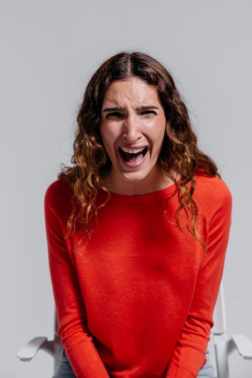 Free Woman in Red Long Sleeve Shirt Shouting Stock Photo