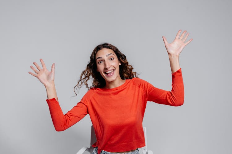 Surprised Happy Woman In Red Long Sleeve Shirt Looking In Excitement