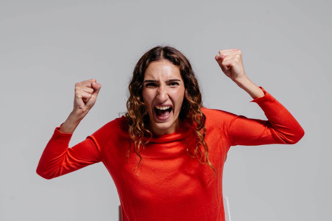 Photo of an Angry Woman in Red Long Sleeve Shirt 