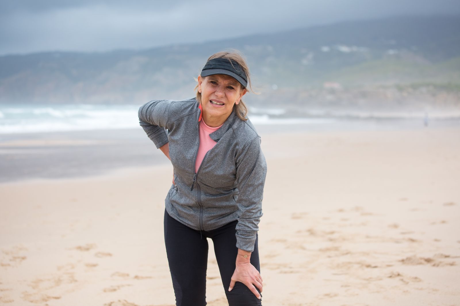 Runner adjusting a knee support before outdoor activity