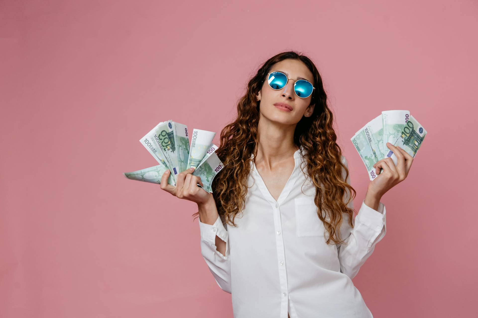 A Woman in White Long Sleeve Button Up Shirt Holding Bank Notes