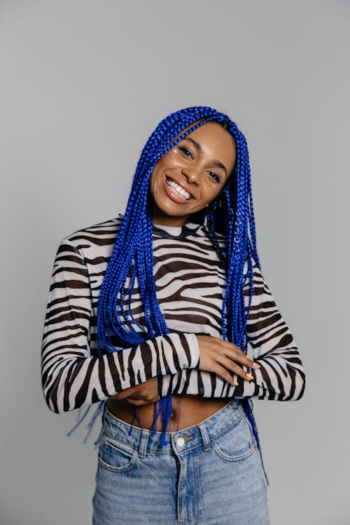 Photo of a Woman with Blue Hair Smiling at the Camera